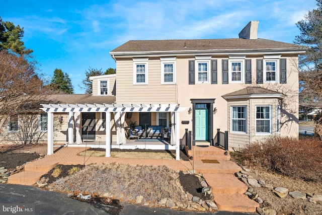 view of front of house with a pergola and a patio