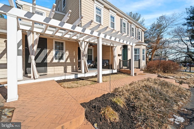 rear view of property with a pergola