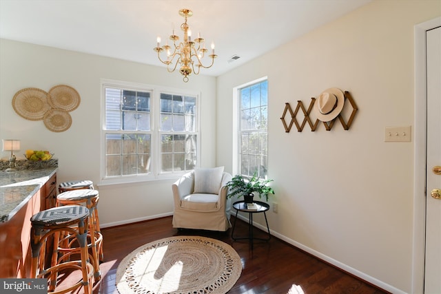 living area with dark hardwood / wood-style floors and a chandelier