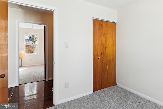 unfurnished room featuring dark carpet