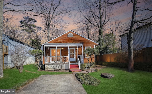 view of front of house with a yard and covered porch