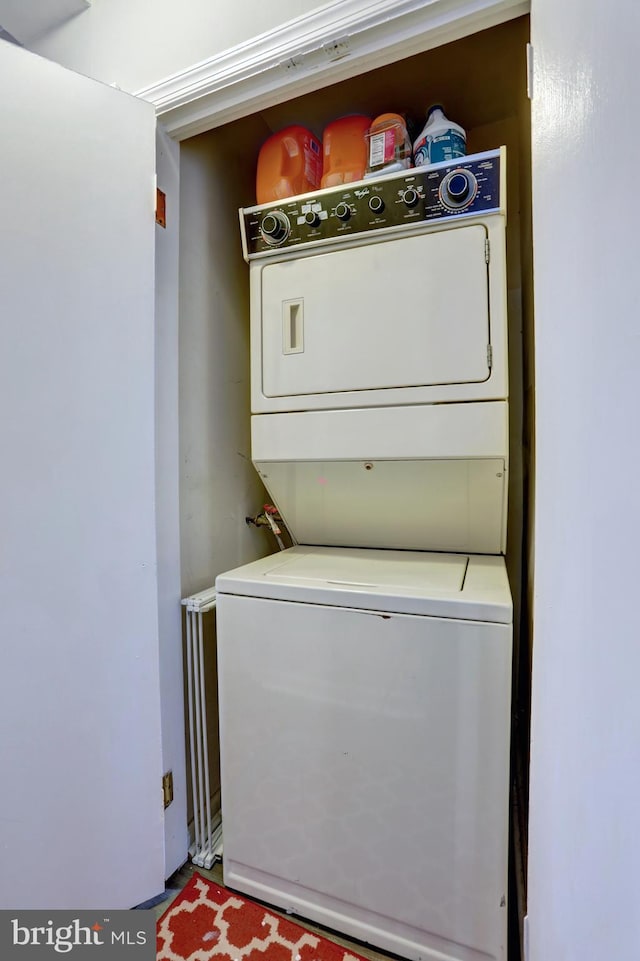 laundry area featuring stacked washer and clothes dryer