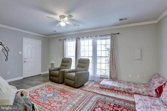 living room featuring hardwood / wood-style flooring, ceiling fan, and ornamental molding