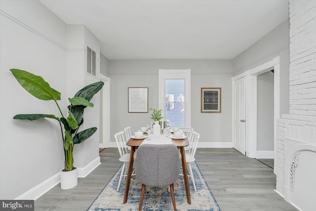 dining space with wood-type flooring