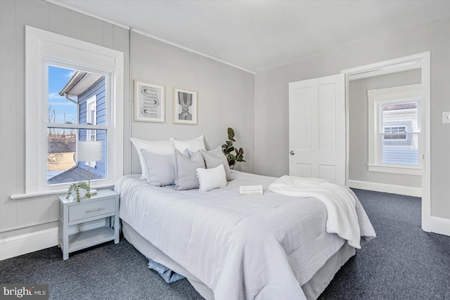 carpeted bedroom featuring multiple windows