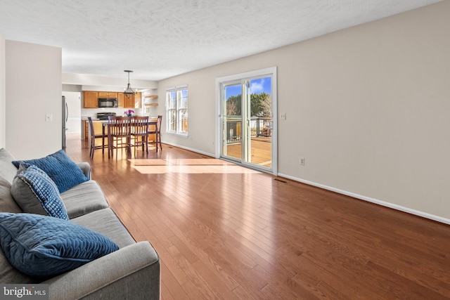 living room with light hardwood / wood-style flooring and a textured ceiling