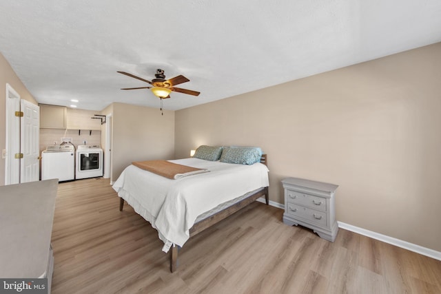 bedroom with ceiling fan, separate washer and dryer, and light hardwood / wood-style flooring