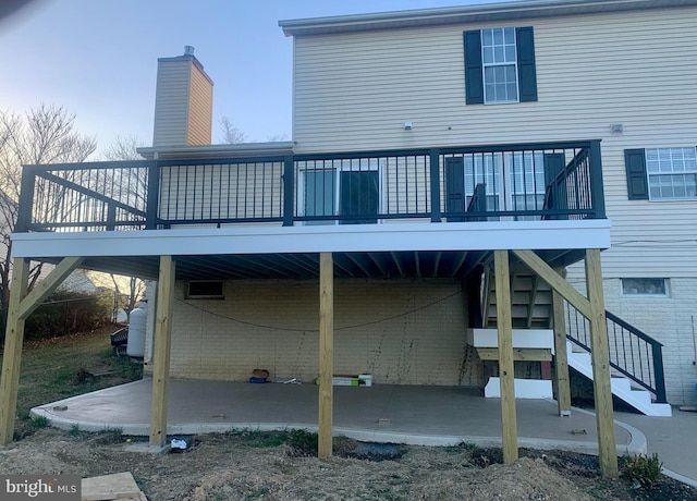 back of house with a patio and a wooden deck