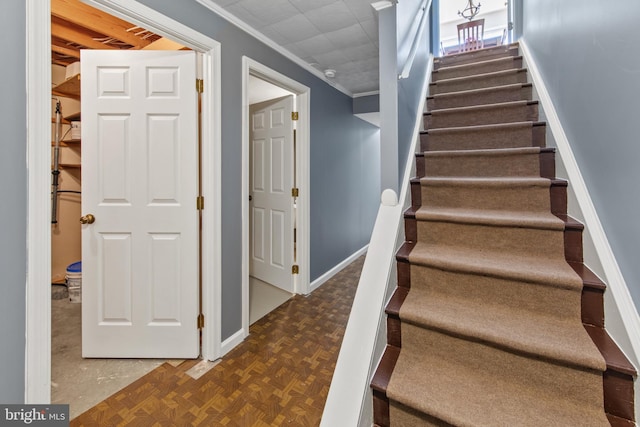 staircase with parquet flooring and ornamental molding