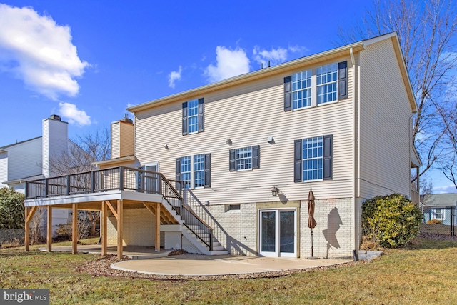 back of property featuring a yard, a deck, and a patio