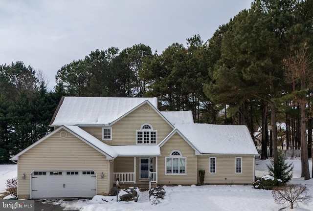 traditional home with covered porch and an attached garage