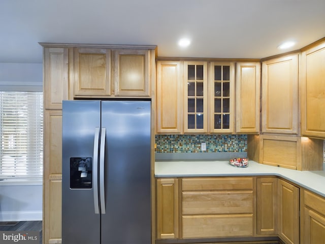 kitchen with stainless steel refrigerator with ice dispenser, dark hardwood / wood-style flooring, light brown cabinetry, and tasteful backsplash