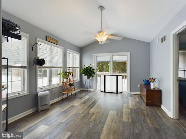 interior space with ceiling fan, dark hardwood / wood-style flooring, and vaulted ceiling