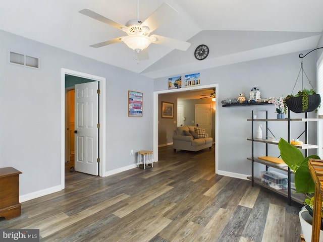 interior space with ceiling fan, dark hardwood / wood-style flooring, and lofted ceiling