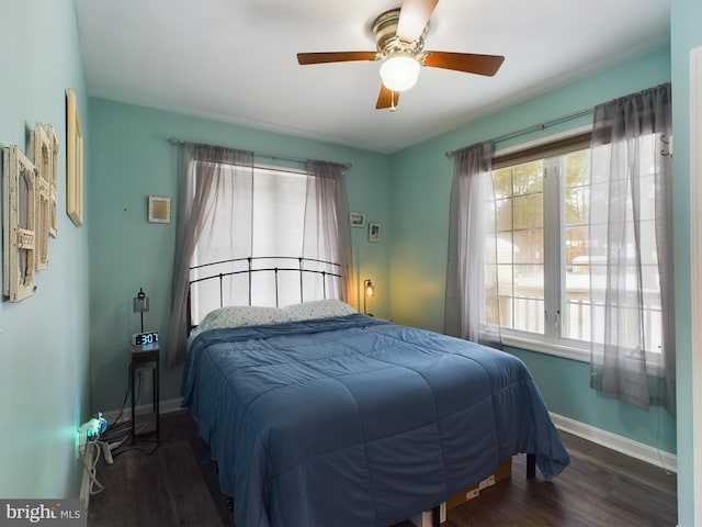 bedroom with ceiling fan and dark hardwood / wood-style floors