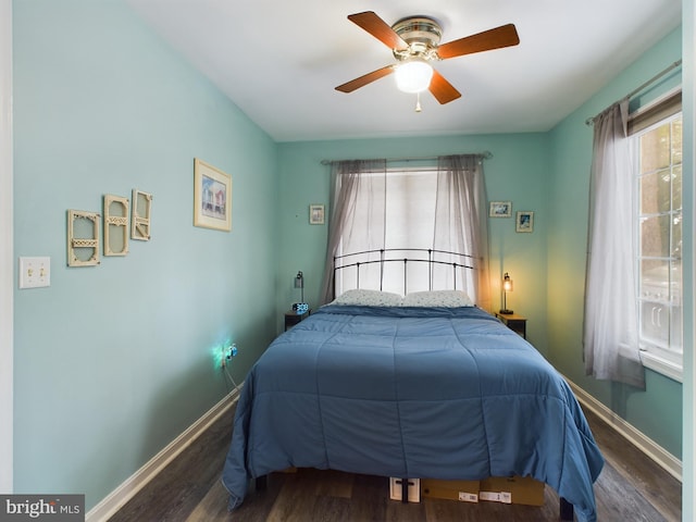 bedroom with dark wood-type flooring and ceiling fan