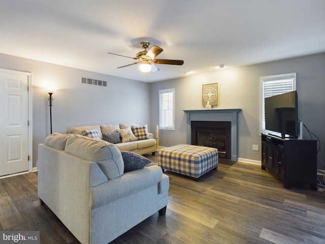 living room with ceiling fan and dark hardwood / wood-style floors