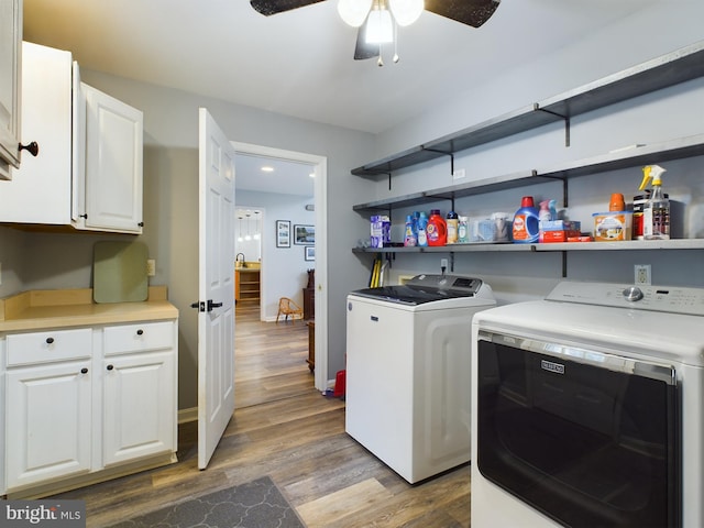 laundry area featuring cabinets, dark wood-type flooring, ceiling fan, and washing machine and clothes dryer