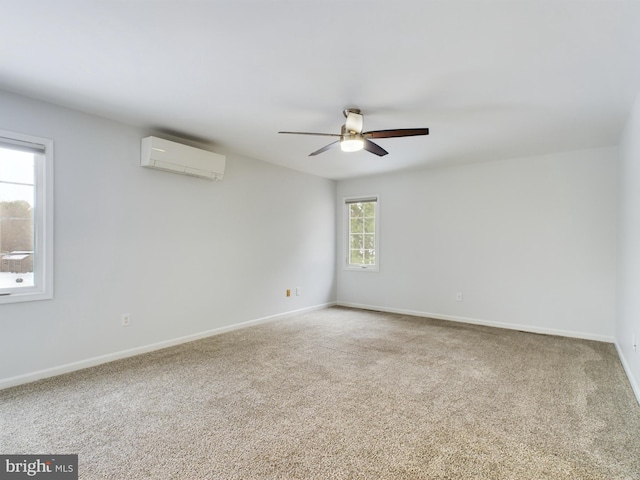 carpeted empty room featuring a wall unit AC and ceiling fan