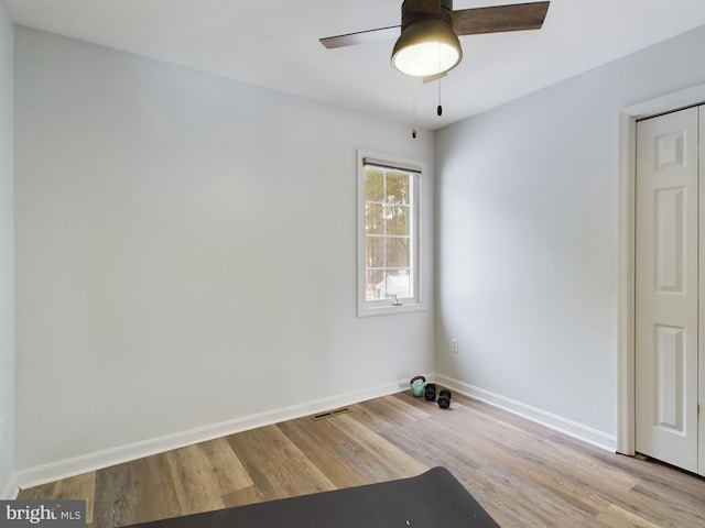 spare room featuring light hardwood / wood-style floors and ceiling fan