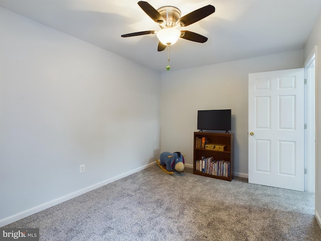 misc room featuring ceiling fan and carpet flooring