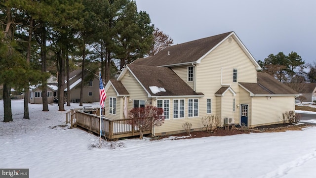 snow covered property featuring a wooden deck