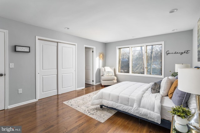 bedroom with a closet and dark hardwood / wood-style floors