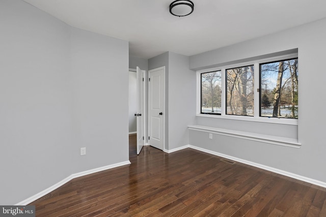 unfurnished bedroom with dark wood-type flooring