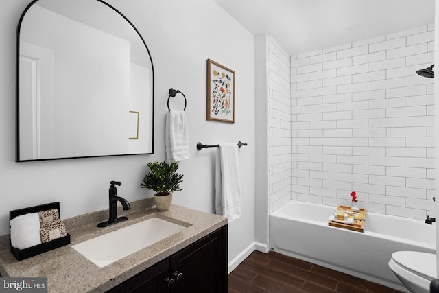 full bathroom featuring toilet, tiled shower / bath, and vanity