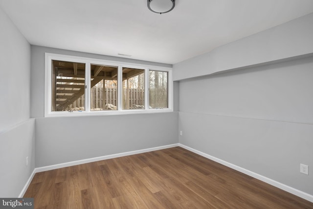 spare room with hardwood / wood-style floors