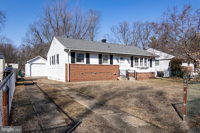 ranch-style home featuring a garage and an outbuilding