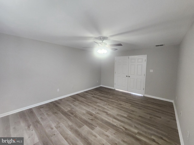 spare room with ceiling fan and wood-type flooring