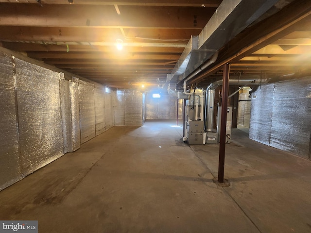 basement featuring water heater and heating unit