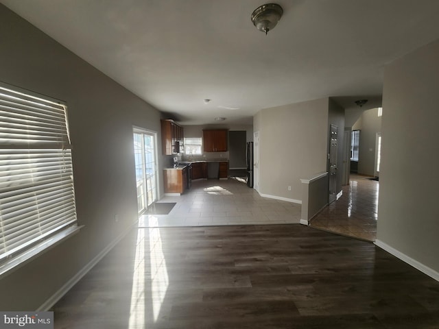 unfurnished living room with dark tile patterned flooring