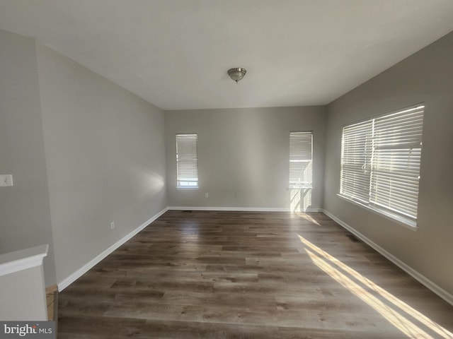 empty room featuring dark hardwood / wood-style flooring