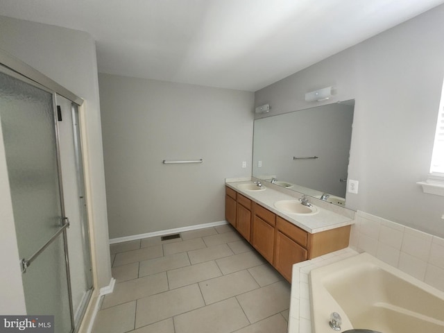 bathroom featuring tile patterned floors, vanity, and shower with separate bathtub