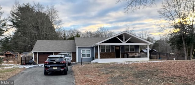 ranch-style home featuring a garage and a porch