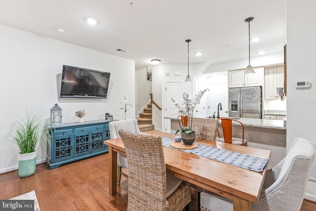 dining room featuring sink and light wood-type flooring