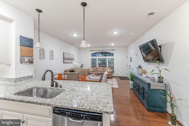 kitchen with sink, decorative light fixtures, stainless steel dishwasher, and white cabinets