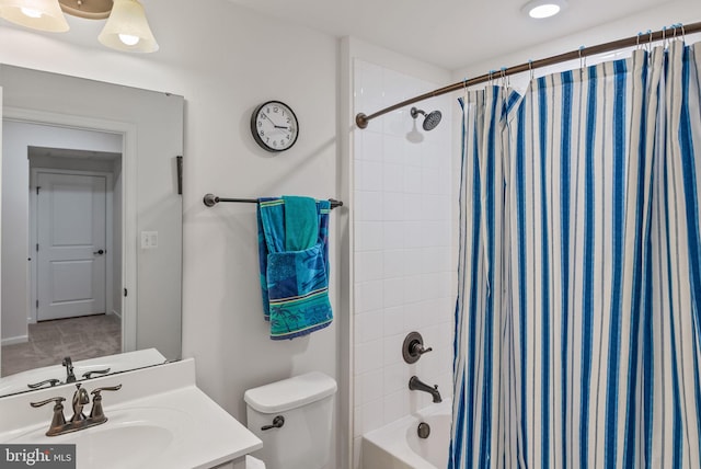 full bathroom with vanity, shower / bath combo with shower curtain, and toilet