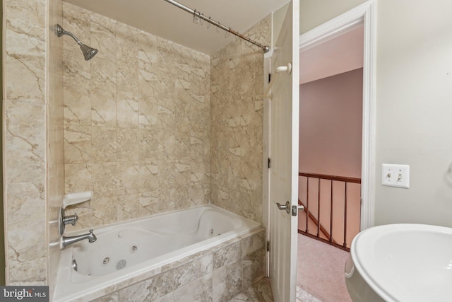 bathroom featuring tiled shower / bath and sink