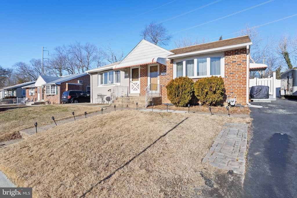 bungalow-style home featuring a front yard