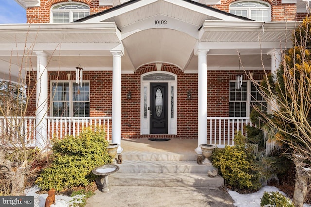 entrance to property featuring a porch