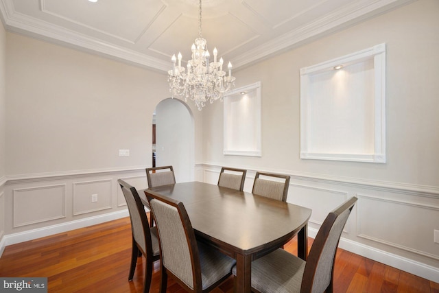 dining space with crown molding, coffered ceiling, and dark hardwood / wood-style flooring