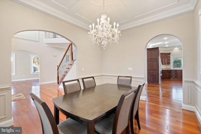 dining area featuring ornamental molding and light wood-type flooring