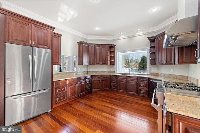 kitchen featuring appliances with stainless steel finishes, sink, dark hardwood / wood-style flooring, crown molding, and wall chimney range hood