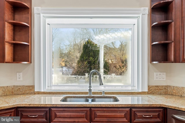 kitchen featuring sink and light stone counters