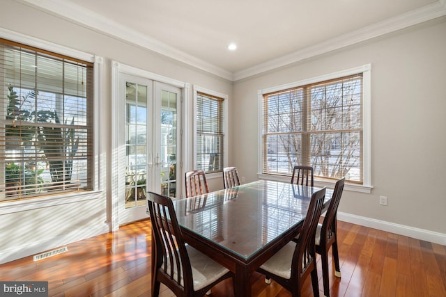 dining room featuring crown molding, dark hardwood / wood-style flooring, and french doors