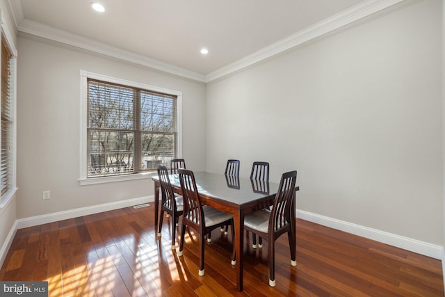 dining room with dark hardwood / wood-style flooring and ornamental molding