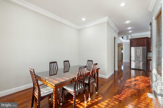 dining space featuring ornamental molding and dark hardwood / wood-style floors